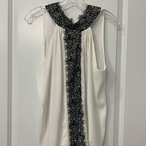 Black and white sleeveless blouse